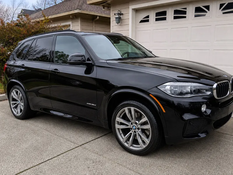 Glossy black BMW X5 after exterior detailing